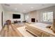 Main bedroom featuring a fireplace, large TV, a plush bed, and natural light from multiple windows at 4162 Matterhorn Way, Las Vegas, NV 89124