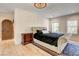 Comfortable main bedroom with carpet, tufted headboard, and natural light at 4162 Matterhorn Way, Las Vegas, NV 89124