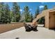 A covered outdoor patio offers a serene seating area with mountain and forest views at 4162 Matterhorn Way, Las Vegas, NV 89124