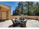 A covered outdoor patio offers a serene seating area with views of the forest at 4162 Matterhorn Way, Las Vegas, NV 89124