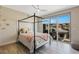 Bedroom featuring a modern four-poster bed with sliding glass doors and a patio at 4290 Solace St, Las Vegas, NV 89135