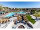 Resort-style community pool area with lounge chairs, umbrellas, and a fire pit for relaxing at 4290 Solace St, Las Vegas, NV 89135