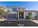 Modern two-story home with a neutral color scheme, stone accents, a two-car garage and a balcony at 4290 Solace St, Las Vegas, NV 89135