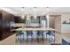 Contemporary kitchen with stainless steel appliances, dark wood cabinets, and a large center island at 4290 Solace St, Las Vegas, NV 89135