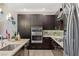 Well-equipped kitchen with stainless steel appliances, sleek dark cabinets, and a functional layout at 4290 Solace St, Las Vegas, NV 89135