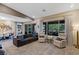 Inviting living room with a comfortable sofa, two armchairs, and large windows with natural light at 4290 Solace St, Las Vegas, NV 89135