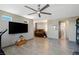 An open floor plan showcases a spacious living room with contemporary tile flooring and a modern ceiling fan at 4290 Solace St, Las Vegas, NV 89135