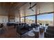 Inviting outdoor lounge with comfortable seating, ceiling fans, fireplace, and community views at 4290 Solace St, Las Vegas, NV 89135