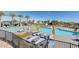 Relax by the community's inviting pool with lounge chairs and umbrellas surrounded by palm trees and modern architecture at 4290 Solace St, Las Vegas, NV 89135