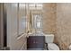 This powder room features a stylish mirror, vanity, and fixtures at 4290 Solace St, Las Vegas, NV 89135
