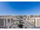 A serene community view showing contemporary homes under a bright blue sky, seen from a balcony with outdoor seating at 4290 Solace St, Las Vegas, NV 89135