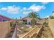 Backyard with desert landscaping, including a palm tree and flowering shrubs at 4629 Denwood Dr, Las Vegas, NV 89147