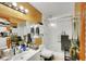 Full bathroom featuring a sink, toilet, and shower with a sliding door, accented with modern wooden panels at 4629 Denwood Dr, Las Vegas, NV 89147