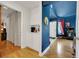 Inviting entryway with hardwood floors, white walls, and a decorative blue accent wall adds elegance to the home at 4629 Denwood Dr, Las Vegas, NV 89147