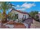 Exterior view of home with desert landscaping, including a palm tree at 4629 Denwood Dr, Las Vegas, NV 89147