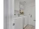 Bright laundry room with side-by-side washer and dryer and storage shelves at 4629 Denwood Dr, Las Vegas, NV 89147