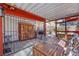 Covered patio with a dining set and access to a wooden storage closet at 4629 Denwood Dr, Las Vegas, NV 89147