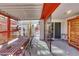 Long covered patio with dining sets and enclosed areas for pets or storage at 4629 Denwood Dr, Las Vegas, NV 89147
