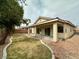 Large backyard offers a covered patio and ample space for outdoor activities and gardening at 4713 Vista Del Rey Ct, North Las Vegas, NV 89031