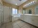 Bathroom featuring double sinks, a shower with tub, and floral wallpaper at 4713 Vista Del Rey Ct, North Las Vegas, NV 89031