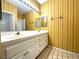 Bathroom featuring double sinks, tile flooring, and vintage gold striped wallpaper at 4713 Vista Del Rey Ct, North Las Vegas, NV 89031