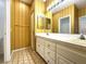 Bathroom featuring double sinks, tile flooring, and vintage gold striped wallpaper at 4713 Vista Del Rey Ct, North Las Vegas, NV 89031