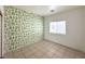Bedroom with neutral-toned tile flooring and a window letting in natural light at 4713 Vista Del Rey Ct, North Las Vegas, NV 89031