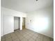 Well-lit bedroom with tiled flooring and a spacious closet with sliding doors at 4713 Vista Del Rey Ct, North Las Vegas, NV 89031