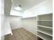 Walk-in closet with built in shelving, a tile floor, and a ceiling light at 4713 Vista Del Rey Ct, North Las Vegas, NV 89031