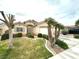 Inviting single-story home with lush front yard and mature palm trees at 4713 Vista Del Rey Ct, North Las Vegas, NV 89031