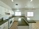 Well-lit kitchen with white cabinetry, ample counter space, and gas range at 4713 Vista Del Rey Ct, North Las Vegas, NV 89031