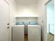 Laundry room featuring a full size washer and dryer, a shelf, and tile floors at 4713 Vista Del Rey Ct, North Las Vegas, NV 89031