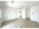 Living room featuring tile flooring and a ceiling fan, with a partial view into the bathroom at 4713 Vista Del Rey Ct, North Las Vegas, NV 89031