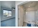 Clean, minimalist bathroom featuring a shower, toilet, and a large window that provides natural light at 5091 E Beacon Ridge Dr, Pahrump, NV 89061