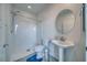 Bathroom featuring a stand up shower, toilet, and a pedestal sink with a round mirror at 5091 E Beacon Ridge Dr, Pahrump, NV 89061
