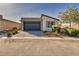 Well maintained single story home with desert landscaping, driveway, and an attached two car garage at 5091 E Beacon Ridge Dr, Pahrump, NV 89061