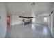 Open-concept living room with a spacious layout and modern kitchen featuring a center island and stainless steel appliances at 5091 E Beacon Ridge Dr, Pahrump, NV 89061