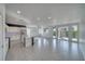 Open concept living space with kitchen and dining areas and sliding door to the backyard at 5091 E Beacon Ridge Dr, Pahrump, NV 89061
