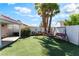 Relaxing backyard featuring artificial grass, mature trees, a hammock, and a swing, ideal for outdoor living at 517 Casa Del Norte Dr, North Las Vegas, NV 89031