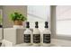 Bathroom shelf featuring decorative plants and matching shampoo, body wash and conditioner bottles at 517 Casa Del Norte Dr, North Las Vegas, NV 89031