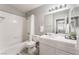 Bathroom featuring a shower-tub combo, large mirror and vanity with sink at 517 Casa Del Norte Dr, North Las Vegas, NV 89031