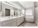 Bright bathroom with double vanity, large mirror, garden tub, and walk-in shower at 517 Casa Del Norte Dr, North Las Vegas, NV 89031
