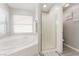 Corner garden tub and glass enclosed walk-in shower in bright bathroom at 517 Casa Del Norte Dr, North Las Vegas, NV 89031