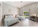 Bright bedroom with two beds, an adjacent desk, and sliding doors to the backyard pool at 517 Casa Del Norte Dr, North Las Vegas, NV 89031