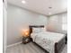 Cozy bedroom with wood frame bed, floral bedding, and bedside tables with lamps at 517 Casa Del Norte Dr, North Las Vegas, NV 89031