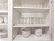 Kitchen cabinet featuring bowls, plates and glasses at 517 Casa Del Norte Dr, North Las Vegas, NV 89031