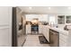 Bright kitchen features stainless steel appliances, white cabinetry, and ample counter space for cooking at 517 Casa Del Norte Dr, North Las Vegas, NV 89031