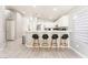 Kitchen island with bar stools and gray vinyl plank flooring at 517 Casa Del Norte Dr, North Las Vegas, NV 89031