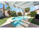 Inviting backyard pool and spa with beautiful landscaping and a charming pergola, perfect for outdoor relaxation at 517 Casa Del Norte Dr, North Las Vegas, NV 89031