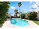 Backyard swimming pool surrounded by lush greenery, flowers and a patio area at 517 Casa Del Norte Dr, North Las Vegas, NV 89031
